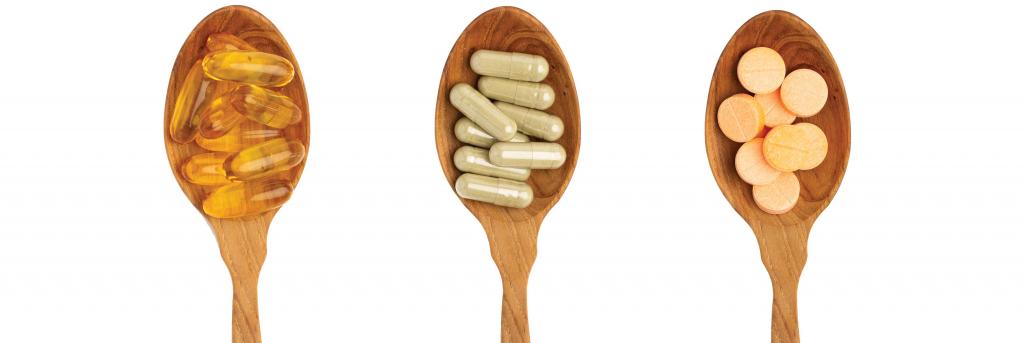3 wooden spoons each full of dietary supplement pills